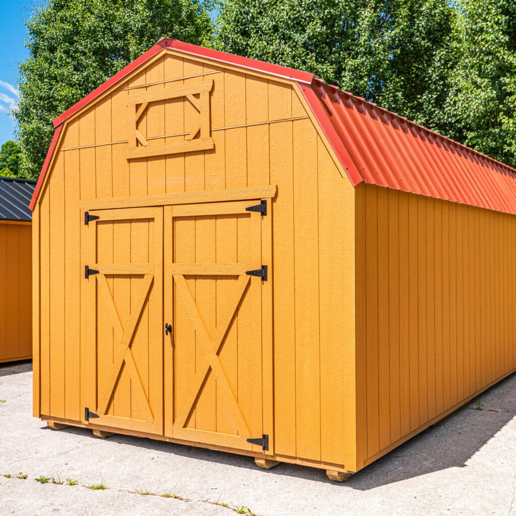 The Shedmax Lofted Barn with a red metal roof.